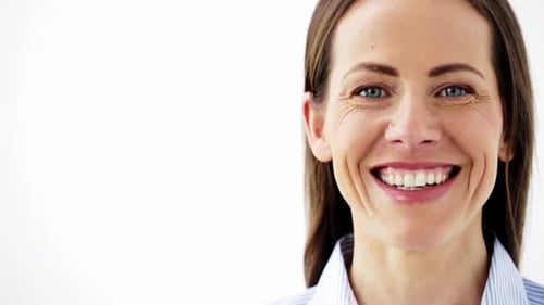 Smiling Woman in Close-Up Against a White Background