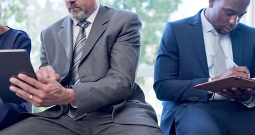 Adults Using Tablets and Taking Notes