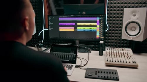 recording studio sound engineer producer mixes songs on screen colorful audio tracks professional