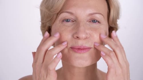 Woman Massaging Her Face and Neck