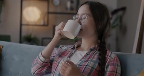Woman Relaxing on Couch with a Mug