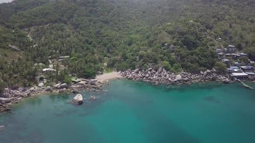 Flying out over quiet bay in Hin Wong, Koh Tao, Thailand