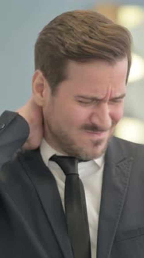 Man Massaging Neck for Relief in Vertical Video
