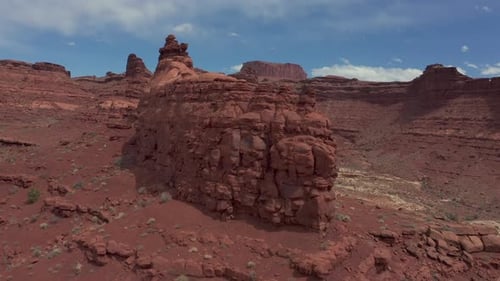 Drone flying over red rocks in arid red desert, Utah. Aerial forward ascendent