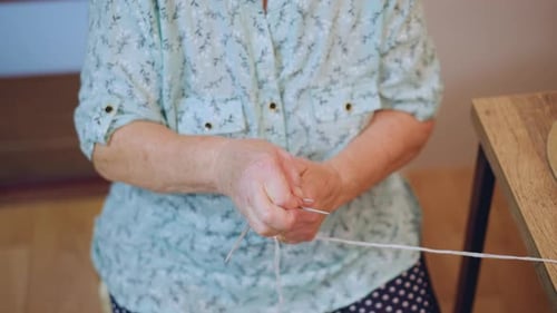 Senior Woman Knitting with Needles Indoors