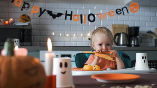 Adorable Infant Celebrates Halloween in Decorated Kitchen