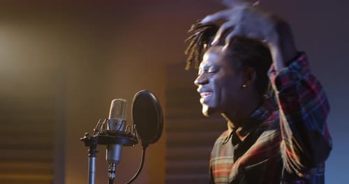Portrait of a Professional Male Black Singer Recording a New Song in a Studio. African Ameri