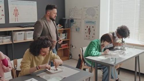 Teacher Watching Students Experimenting