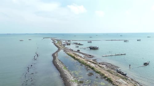 Serene Coastal Landscape Featuring Fishing Structures and Open Water