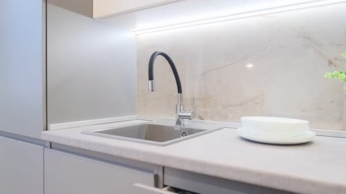 Modern Kitchen Sink with White Plates on Counter