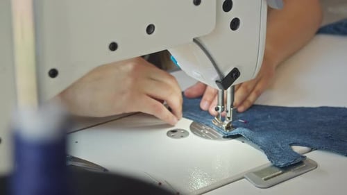 Sewing Machine Stitching Denim Fabric in Workshop