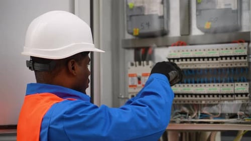 Electrician Working on an Electrical Panel Installation