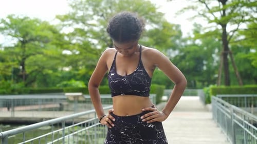 Afro young african american woman with warm up and practicing yoga in park backyard