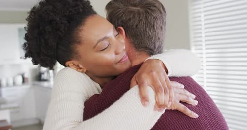 Woman Embracing Man Affectionately Indoors