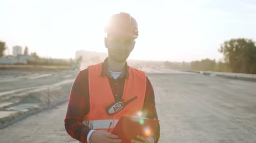 Portrait of Builder in Special Clothes for Work on Site