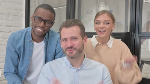 Blogging Multi Ethnic Teammates Doing Video Chat in Office