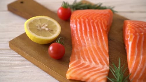Two Raw Salmon Filets on a Wooden Board