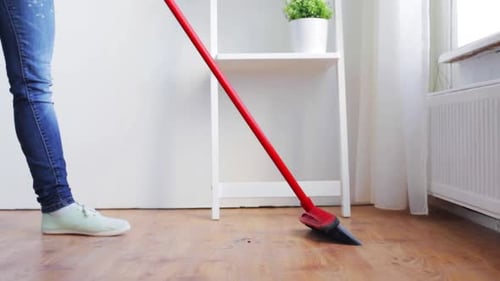 Woman Sweeping Floor in Bright, Clean Home