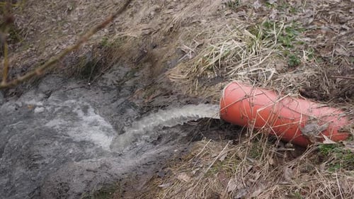 Water Flows from Drainage Pipe into River