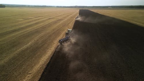 Tractors plowing the field in Ukraine