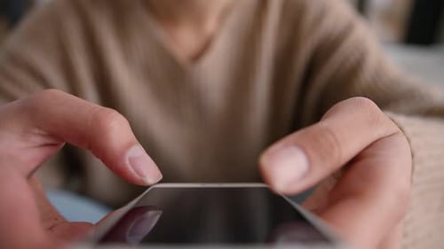 Cropped Shot of Woman Using Smartphone Screen Scrolling Browsing Online at Home Mobile Phone