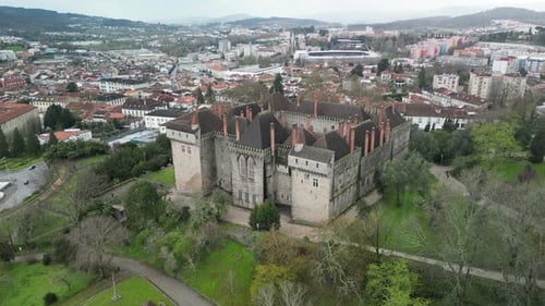 Aerial view of Castelo de Guimaraes, greenery, historic buildings, Portugal.