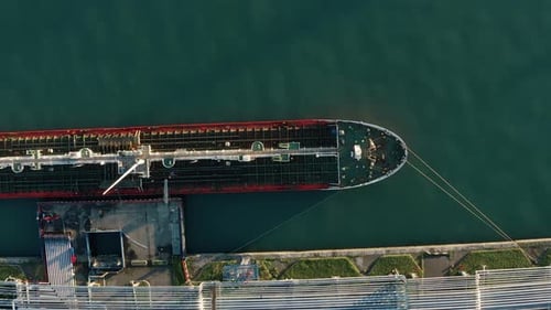 Aerial Top Down View Oil Ship Tanker Vessel Loading in Gas and Oil Terminal Station Refinery Global