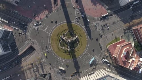 Aerial drone view of Plaza of Spain in Barcelona, Spain. Roundabout with moving cars