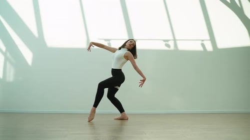 Young Female Dancer Performing Contemporary Dance in a Studio