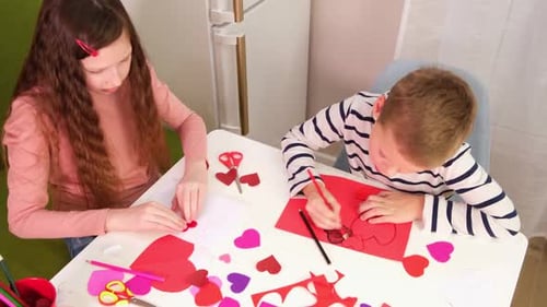 Valentines Day Kids Crafts Paper Heart Tracing and Cutting Out Hearts From Pink Paper for Valentines