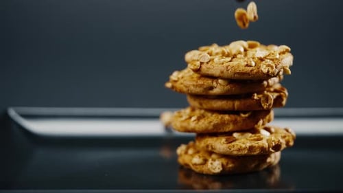 Close Up on Black and Blue Background Flat Plate with Cookie Cookies Built in a Pyramid Sweet