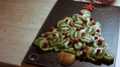 Kiwi Christmas Tree with Cranberries on Cutting Board