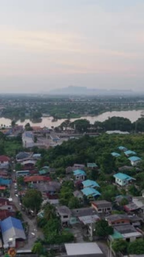 Aerial View of Houses Near the Lake in a Rural Area Next to the Road in Thailand