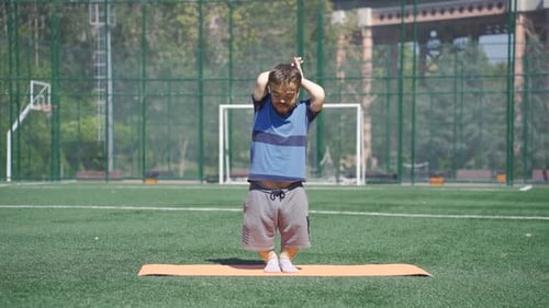 Athletic Man Doing Yoga on a Field