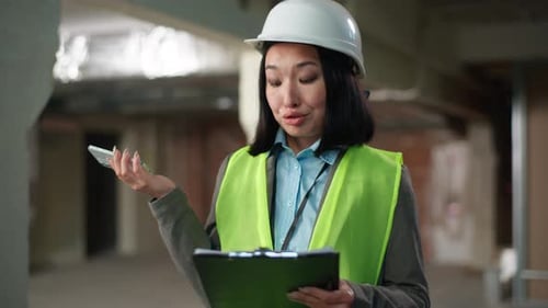 Stressed Asian Japanese Woman Talking Mobile Phone Builder Discuss Documents Problem Building Plan