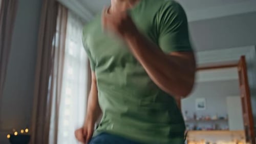 Young Adult Male Jogging in Place at Home