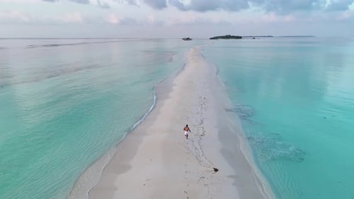 Running like a child on the endless sandbank of Dhigurah in the Maldives