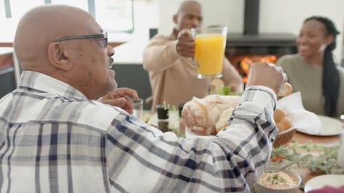Family Gathering Around Table Preparing Meal