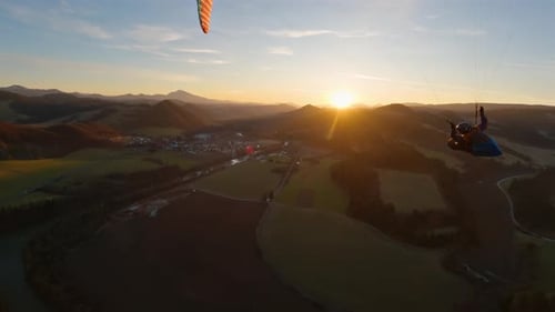Swing on Paragliding Wing at Golden Sunset