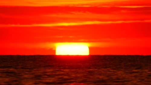 Sunset Ocean Horizon Vibrant Red Orange Sky Sun Disappearing Into Calm Water Dramatic Natural Beauty