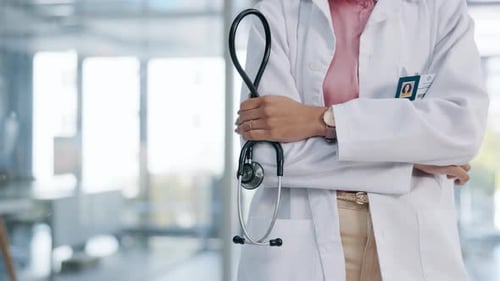 Medical Professional Holds Stethoscope in Brightly Lit Office