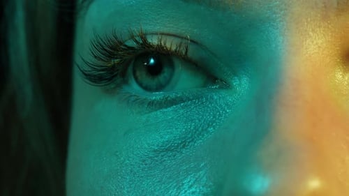 Closeup Womans Blinking Eye with Long Eyelash and Contact Lens Beauty Make Up of Green Eye with Neon