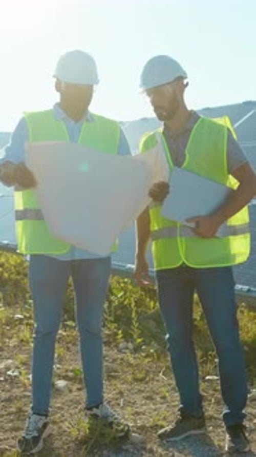 Dedicated Engineers Actively Working on a Solar Panel Installation Site Focused on Sustainability