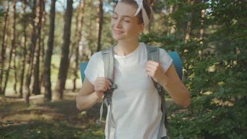 Slow Motion Woman Young Tourist with Backpack Walking in the Fall Forest on Sunny Summer Day Smile