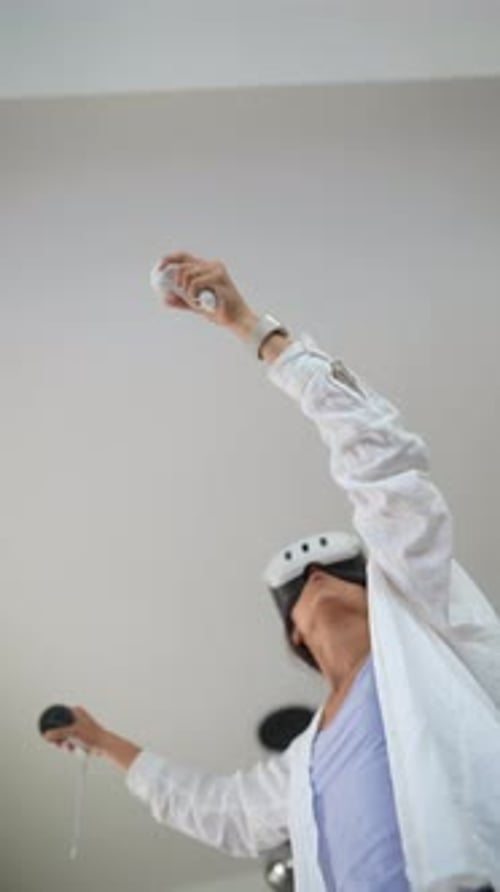 Young Woman Playing VR Game at Home
