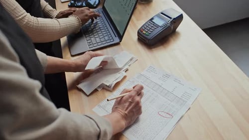 Small Business Owners Looking through Bills