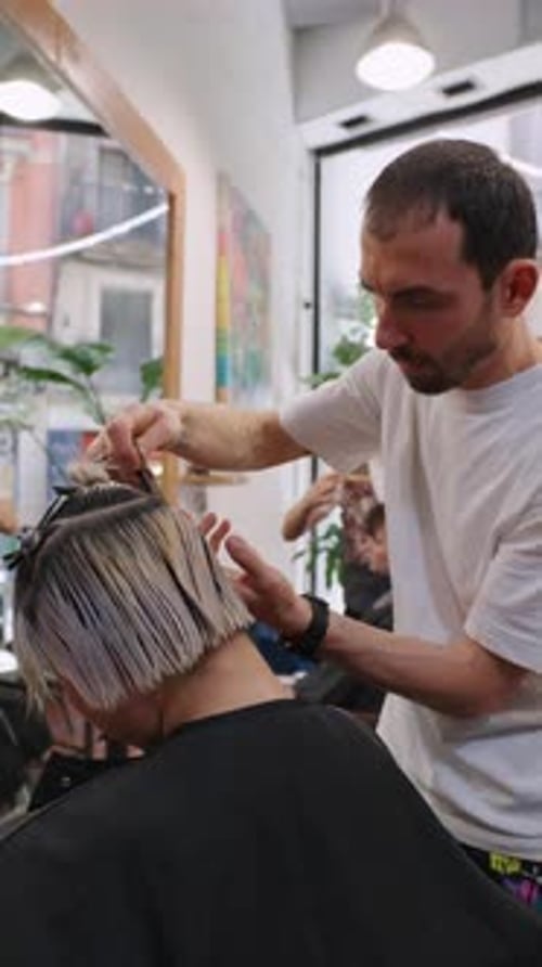 Man Styles Short Blonde Hair at Salon