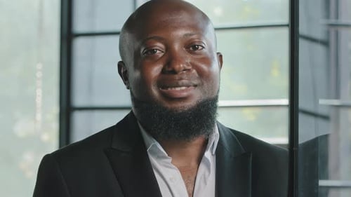 Smiling Man in a Suit Inside an Office