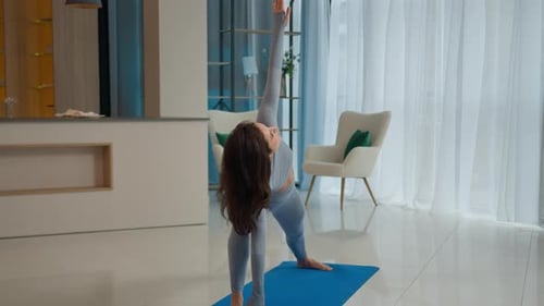 Woman Practicing Yoga Poses at Home on Mat