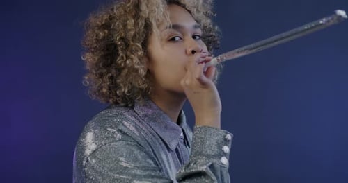 Young Adult Celebrates with Party Noise Maker